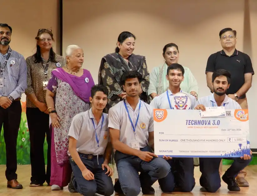 Gurukul Global School team receiving their ₹1,500 third prize cheque on stage
